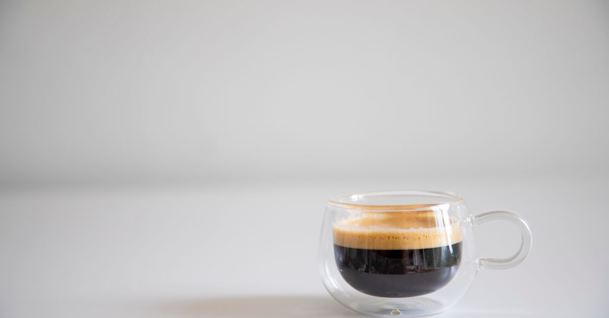 Simple and elegant espresso cup shot on a white background, highlighting the coffee's crema.